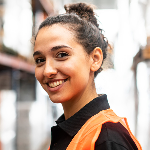 Close-up of a happy woman working in warehouse
